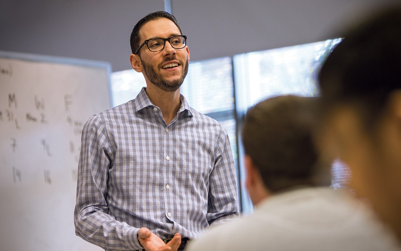 Music Theory faculty member teaches a class in front of a white board