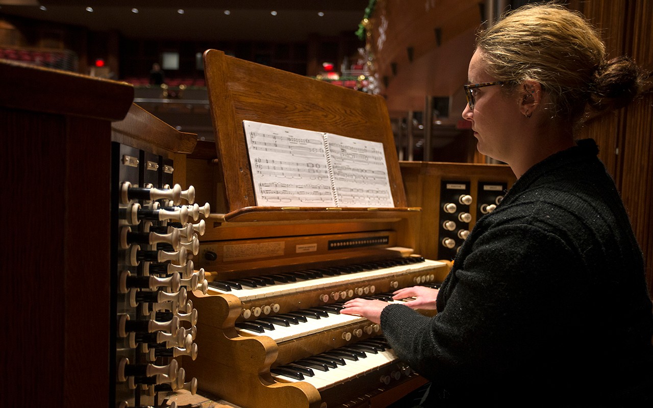 A female organ student performs in the Feast of Carols concert in Corbett Auditorium